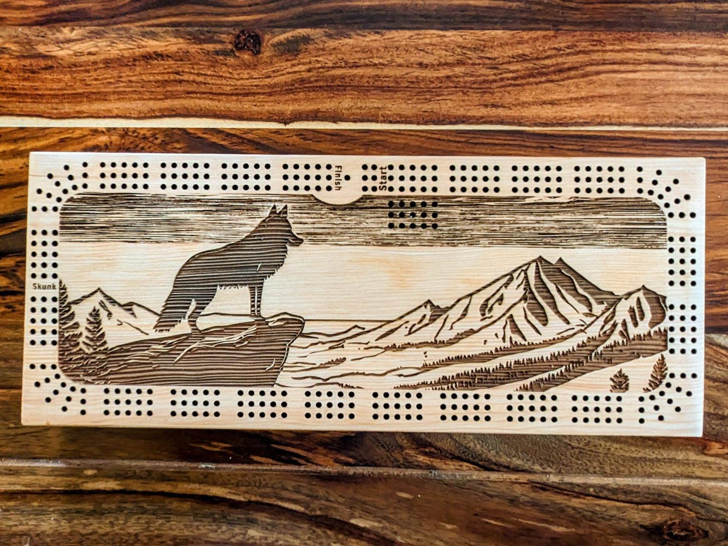 A wolf looking over a valley, 3 Track Cribbage Board - Laser engraved